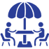 Two people sitting at an outdoor table.