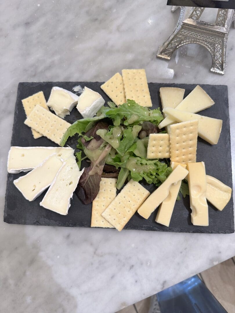Cheese and crackers on slate platter.