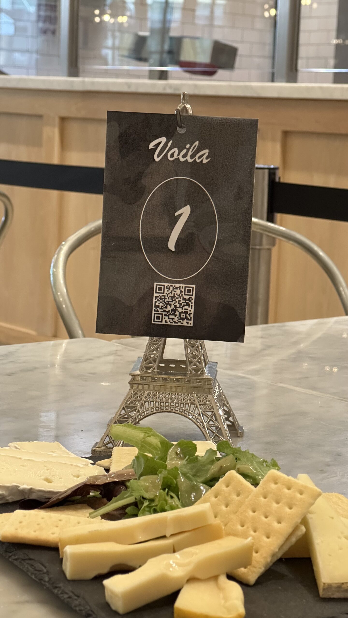 Cheese platter with Eiffel Tower sign holder.