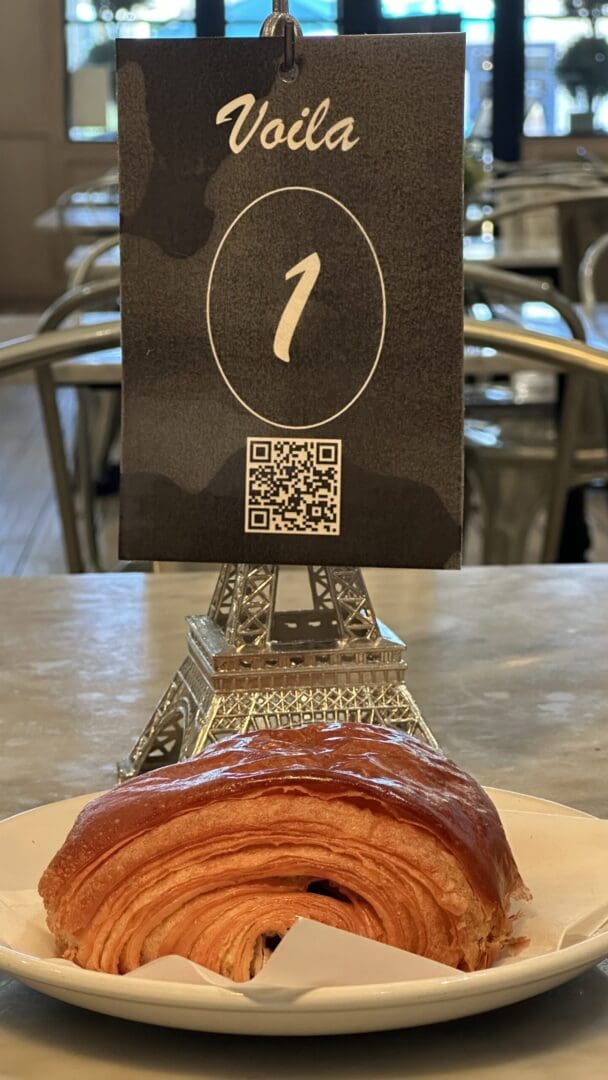 Croissant on plate with table number sign.