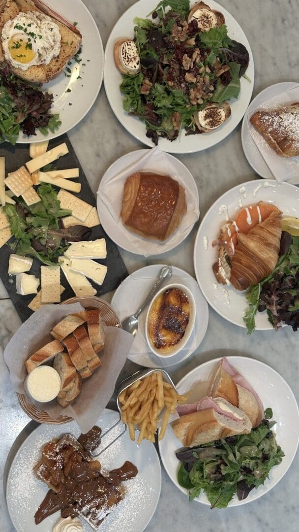 Assorted brunch dishes on marble table.