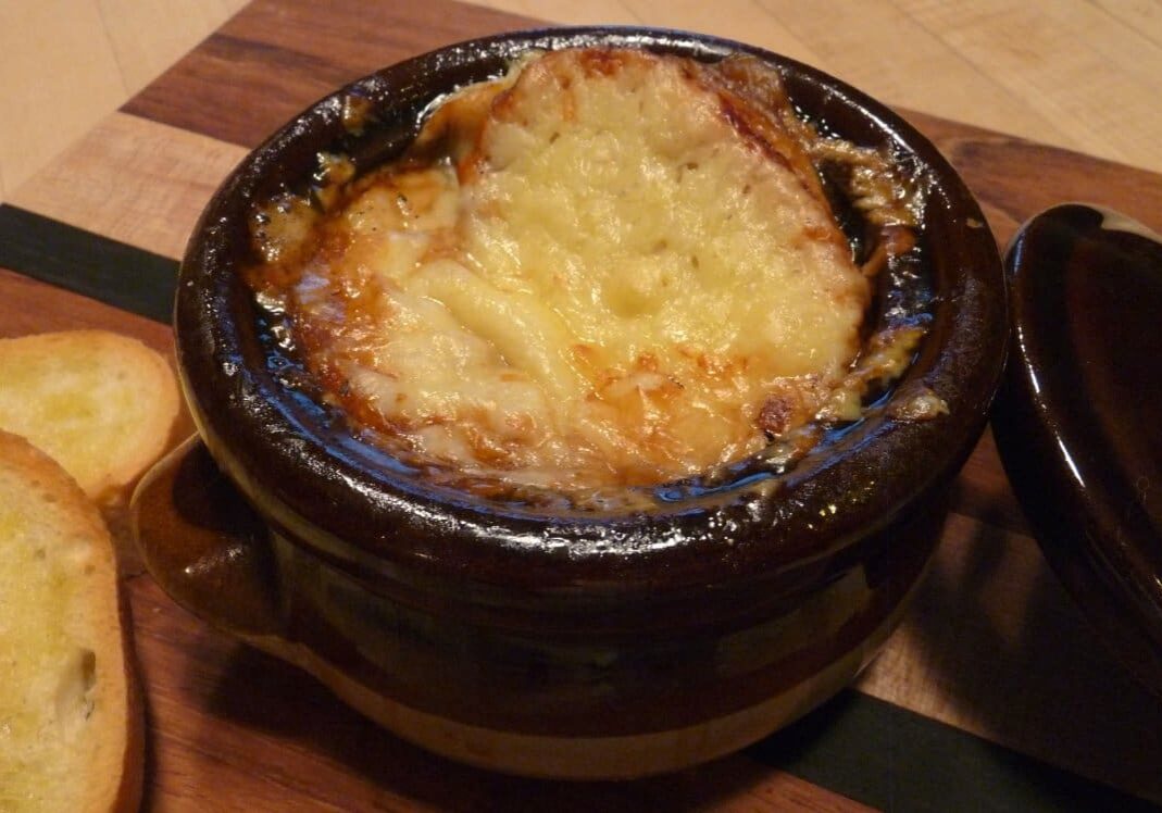 Baked French onion soup with toasted bread.